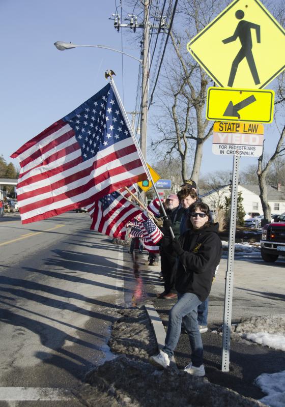 People lined Route 6 with flags in hand to show respect for the 19-year-old man killed in action. BY GEORGIA SPARLING