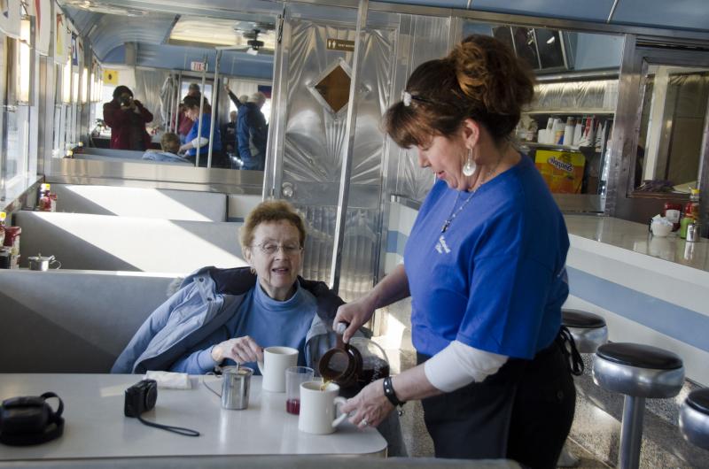 Waitress Debbie Talbot serves up freshly ground and brewed coffee to patron Fran Ward. BY GEORGIA SPARLING