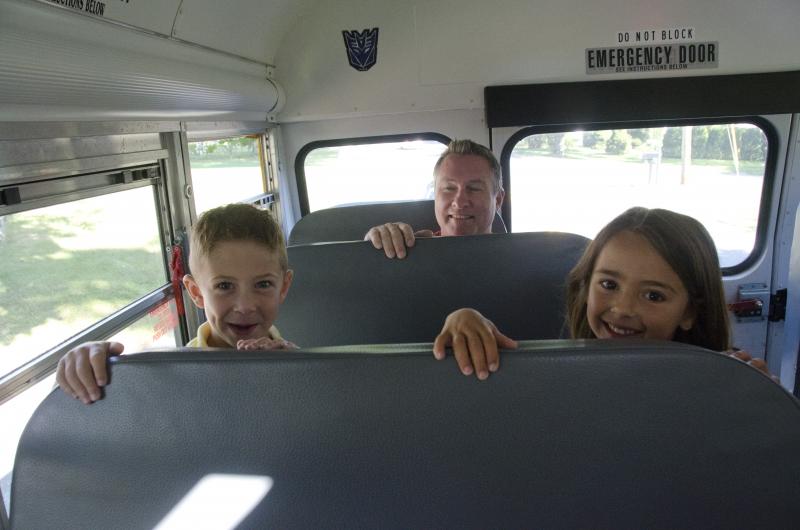 Friends Landon Maher and Abby Fortin were excited for their first day at school. Dad, Ed Maher, was one of many parents who accompanied their child on the bus to Center School Tuesday morning. BY GEORGIA SPARLING