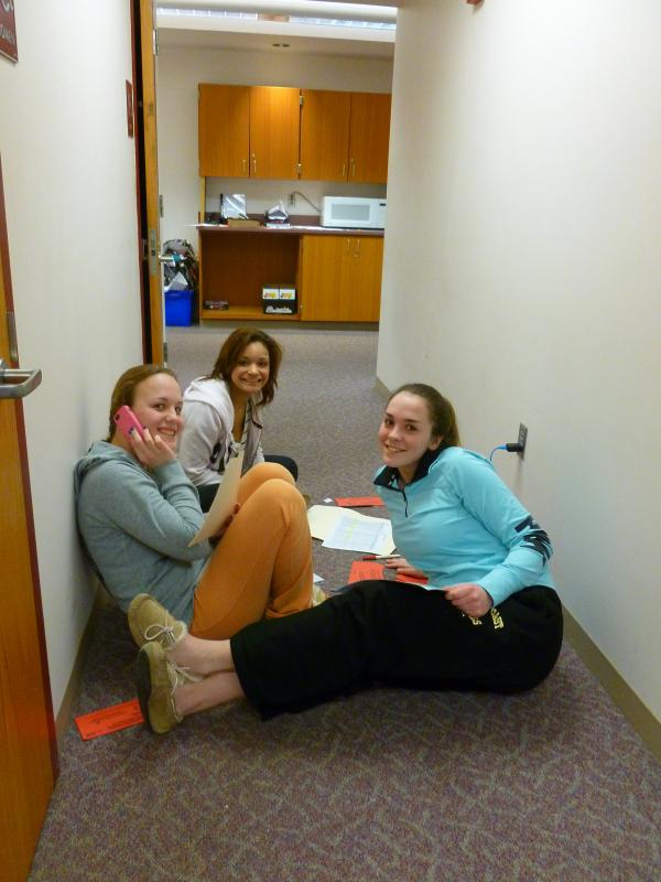 Front to back: Ella Vercellone, Mia Vercellone and Autumn Carter look up from their phone calling. BY JULIA NOJEIM