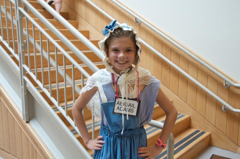 Third grader Sara Costa smiles in her Abigail Adams outfit before the Great American Breakfast. BY GEORGIA SPARLING