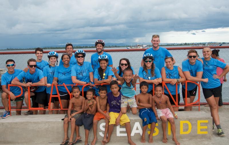 Rise Up Ride On cyclists tour a playground built by All Hands Volunteers in Tacloban City. COURTESY GEORGIA SPARLING