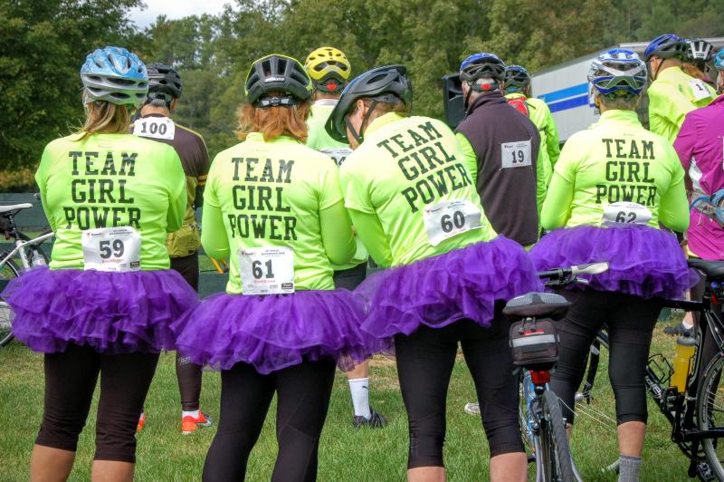 Members of team Girl Power, one of the largest teams to participate this year, listen to instructions before the 35-mile race begins. BY SARA LAFRANCE