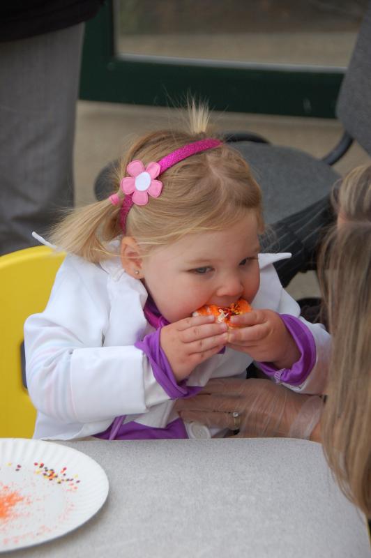 Nom nom nom. Two-year-old Calligh Enos from Rochester enjoys a cookie at the cookie decorating station. BY SARA LAFRANCE