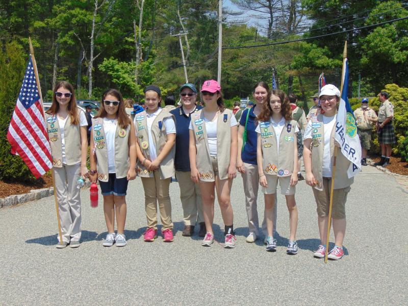 Girl scout troops 80099 and 81001 pose before marching in Rochester's parade to honor fallen soldiers. BY TANNER HARDING