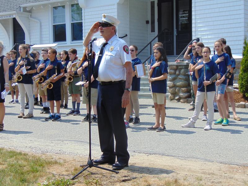 Scott Weigel, Rochester's fire chief, leads ceremony attendees in the Pledge of Allegiance. BY TANNER HARDING