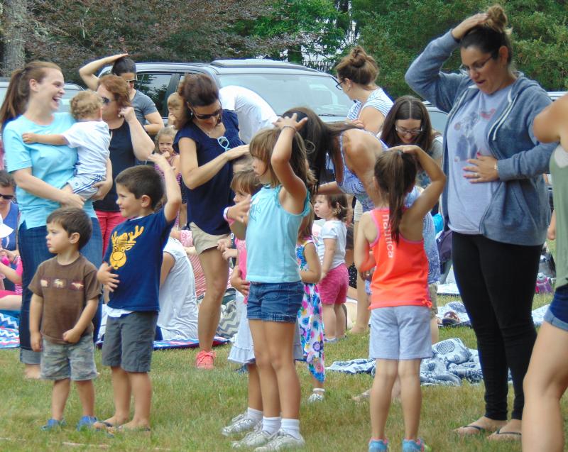 The adults get involved too when after a quick do-si-do, everyone was told to "pat your head and rub your tummy." BY TANNER HARDING