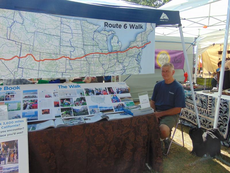 Joe Hurley, author of "Ten Million Steps on Route 6," sells copies of his book documenting his nine-month journey walking from Cape Cod to California. BY TANNER HARDING