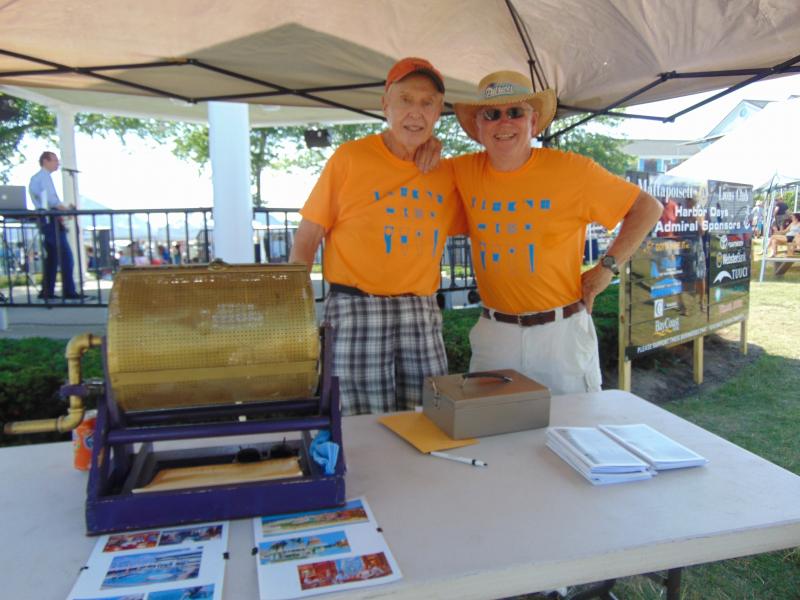 Bill Calusine and Rick Price take a quick break from selling raffle tickets to pose for a quick photo. The two prizes are seven-night all inclusive vacation packages. BY TANNER HARDING