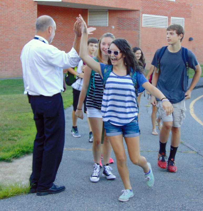 An excited student high-fives ORR Junior High Principal Kevin Brogioli on her way into school. BY TANNER HARDING