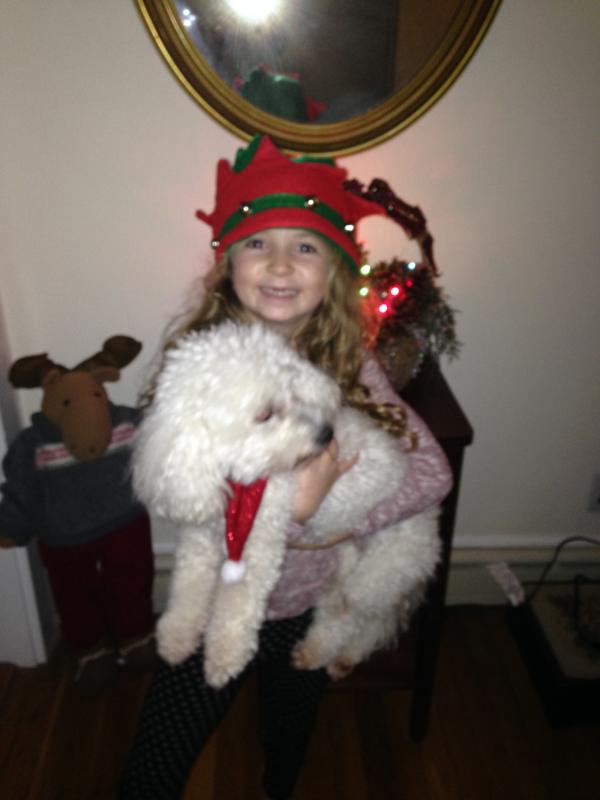Emma Kendrigan cuddles with Tessie, her grandmother's bichon that recently passed away. BY KATHY MOORE