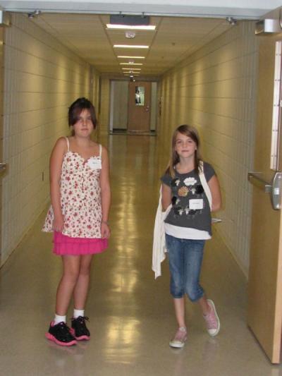 Fifth graders Mara Flynn and Kelsey Kidney prepare to lead a tour group down the renovated corridor leading to the school's newly constructed addition. BY ANNE EISENMENGER