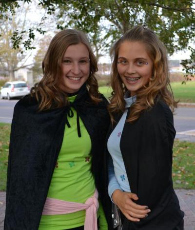 Morgan Middleton (left) and Kristina Sauerbreey wait outside the Marion Music Hall watching the younger kids head inside for trick-or-treating, BY JENNIFER HESHION