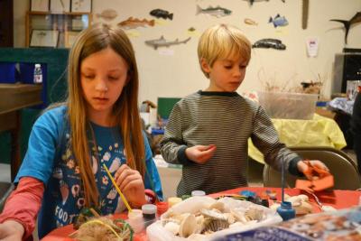 Morgan Miedema, left, and Max Richins, right, make pin-cushions using sea glass, poly-fil and sea shells. BY JENNIFER HESHION