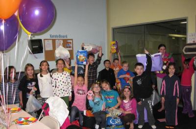 Mia Oliveira and friends sort through some of the donations for the animal shelters. COURTESY TARA OLIVEIRA