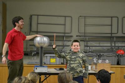 David Reynolds, right, waits to find out of the copper stick he is holding is a good conductor of electricity. It was. BY JENNIFER HESHION