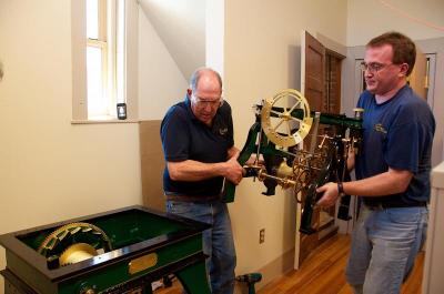 Ray Balzer, left, said the complete clock was a small 3,800 pounds (although this piece here looks pretty heavy). BY GEORGIA SPARLING