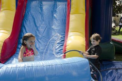 Amelia Earnshaw and Ty MacKenzie enjoyed the blowup water slide on the warm Saturday afternoon. BY GEORGIA SPARLING