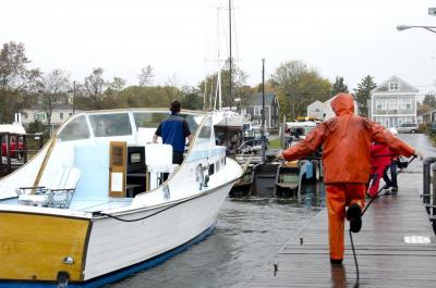 Mattapoisett native Nils Johnson was one of the last people to get his boat out of the water as the winds picked up Monday morning. BY GEORGIA SPARLING