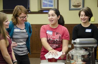 Mattie's students helped make her buttercream frosting. Emily Newell, center, helped by sifting confectioner's sugar. BY GEORGIA SPARLING
