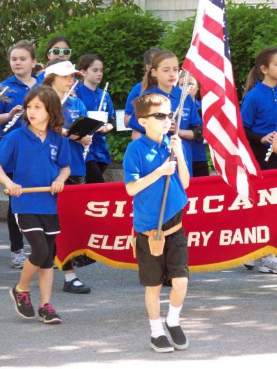 Members of the Sippican School band march in the parade while playing "It's a Grand Old Flag." BY MATTHEW BERNAT