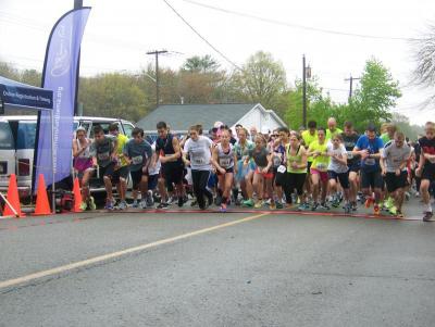 The race begins as runners sprint from the starting line at 98 County Road in Mattapoisett. BY MATTHEW BERNAT