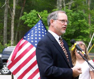 First Congregational Church Pastor Glenn Stone offers a prayer on behalf of soliders who died. BY MATTHEW BERNAT