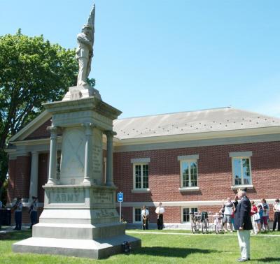 Dick Langhoff, of the Florence Eastman Post 280 American Legion, laid down a wreath at the war memorial beside the Mattapoisett Library. BY GEORGIA SPARLING