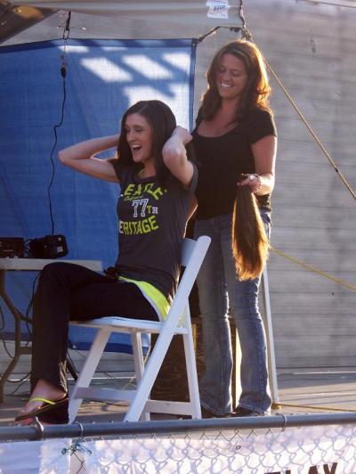 Shannon Precourt loses 15 inches of hair courtesy of Jodie Perry. The hair was donated to make wigs for cancer patients. BY MATTHEW BERNAT