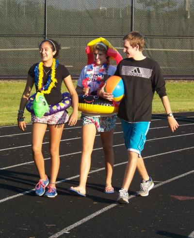 From left, Sarah Belliveau, Nina Bourgeois, and Michael Kassabian look ready to hit the beach as they walk the track. BY MATTHEW BERNAT