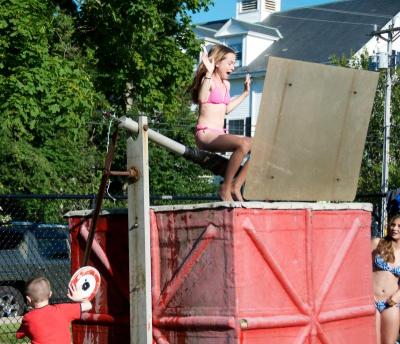 After many failed to dunk Sarah Moitozo the old fashioned way, one kid sends the sixth grader into the chilly waters of the tank with a push of the lever. BY GEORGIA SPARLING