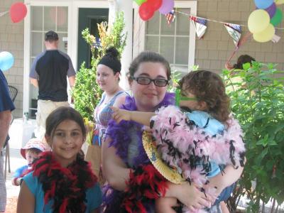 Sisters Tori and Meghan Tripp of Marion (left and right) and cousin Angela Desrochers of Acushnet get ready for another visit to the photo booth. BY ANNE EISENMENGER