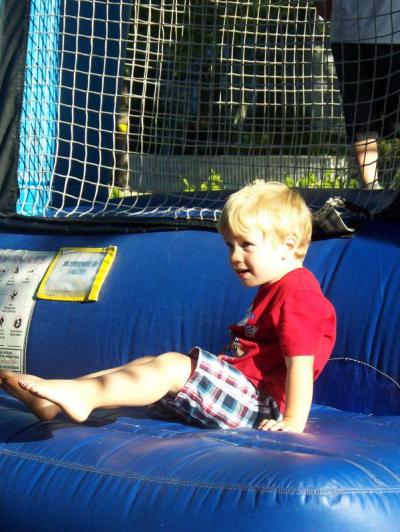 Always popular, the bounce house attracted a steady stream of kids. Here, Boden Soucy, of Rochester, bounds out to see his parents. BY MATTHEW BERNAT