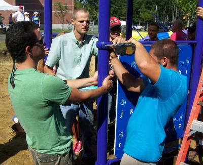 From left, Tom Forcier, Jaime Tebow, and Anthony Leoni secure part of the playground. BY MATTHEW BERNAT