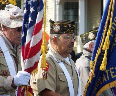 Ron Barrows, center, stands between Doug Thackery, left, and Bob Jones, right. The men presented the colors at the ceremony. BY MATTHEW BERNAT