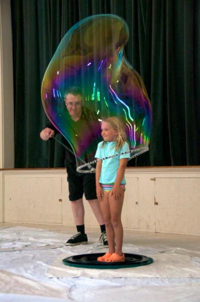 Molly Dupre learns about bubbles first hand during Keith Johnson's Bubbleology show in Mattapoisett. BY GEORGIA SPARLING