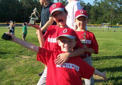 Hunter Bishop, Jackson Gierhart and Austin Hathaway celebrate Old Rochester Little League's first season. BY MATTHEW BERNAT