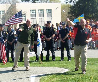 Rochester Parks Department Chair David Hughes, left, and Marion Recreation Department Director Jody Dickerson throw the first pitch. BY MATTHEW BERNAT