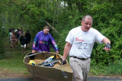 Marc Nadeau and Jodi Bauer cross Cushman Road at a portion of the Mattapoisett River too narrow for boaters. BY GEORGIA SPARLING