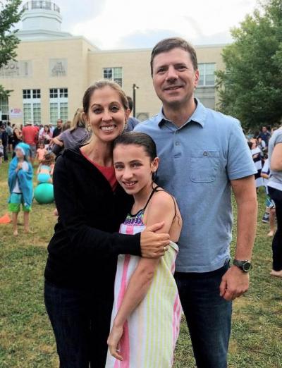 The Shultz family poses for a photo after Christina Shultz returned from her third dunking. Sarah Shultz (left), Christina Shultz (center), and Matt Shultz (right). BY ERIN BEDNARCZYK