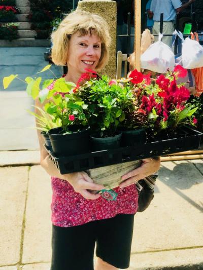 Barbara Moody, of Marion, bought a cache of plants for her garden at the fair's plant sale stand. BY CHRIS REAGLE