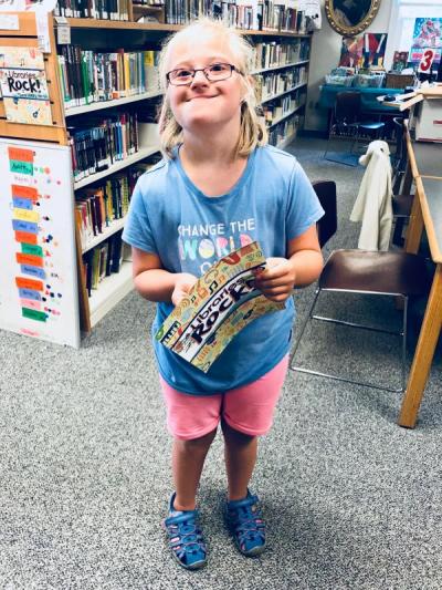 Eve Antonellis, 10, a 5th grader, at Rochester Memorial School, shows how she's keeping track of her reading through Plumb Memorial Library's "Libraries Rock" summer reading program. BY CHRIS REAGLE