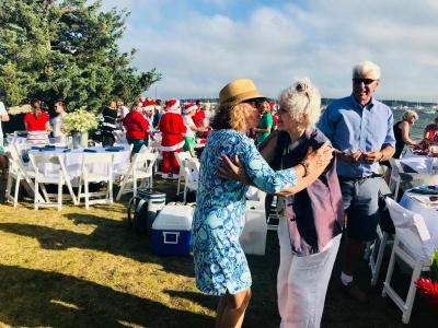 Randy Smith smiles with delight as Mary Cabral, left, and Ellen Flynn greet each other. The ladies are both members of the Mattapoisett land Trust. BY CHRIS REAGLE