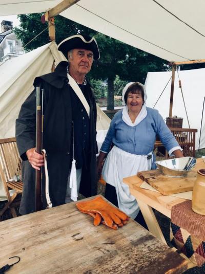 Howie and Claire Smith of the Wareham Militia take a moment from their duties as soldier and candlemaker during the Colonial War encampment. In her alternate life, Claire Smith is Wareham Town Moderator. BY CHRIS REAGLE
