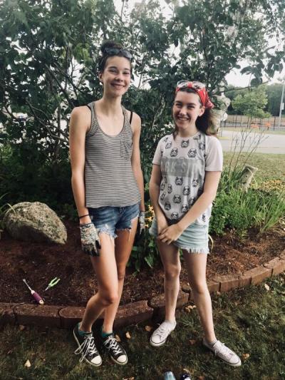 Best friends and Old Rochester Regional High School seniors Abigail Lacock, 17, left, and Madeleine Roots, 17, are two of the many students who've helped maintain the schools memorial gardens. BY CHRIS REAGLE