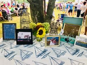 A display table at Marion Town Party explains the towns involvement with Bird Island Lighthouse. Proceeds from the town party food concessions will go to some of the island and lighthouse restoration project.