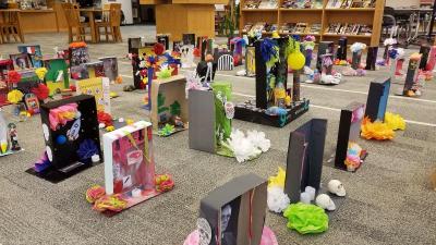 The colorful backs of student altars, on display in the library. Photo courtesy: Diana Carreira and Allison Barker