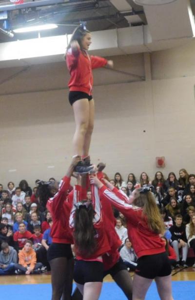 The cheerleading team lifts Reign Fernandes up at the pep rally on Friday. Photo by: Grace Ballenger
