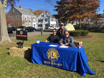 The three gentlemen at the Membership table are, left to right, King Lion James Nadeau and Timothy Ray, Secretary (in the front row). Back row: Ross Kessler, Club member. Photo Courtesy: Mattapoisett Lions Club