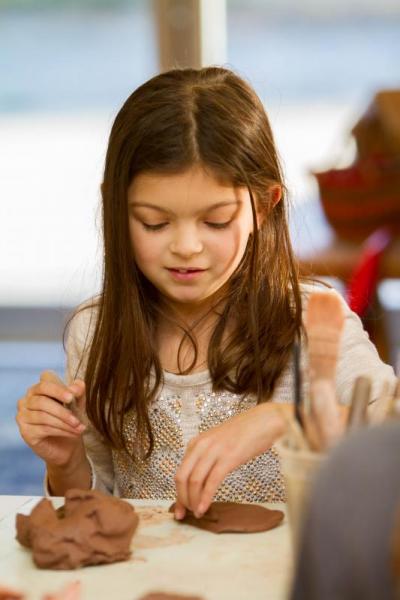 Caydence Pinheiro of Rocheser begins work on what will become her clay Adventure box. Photo by: Andrew Griffith